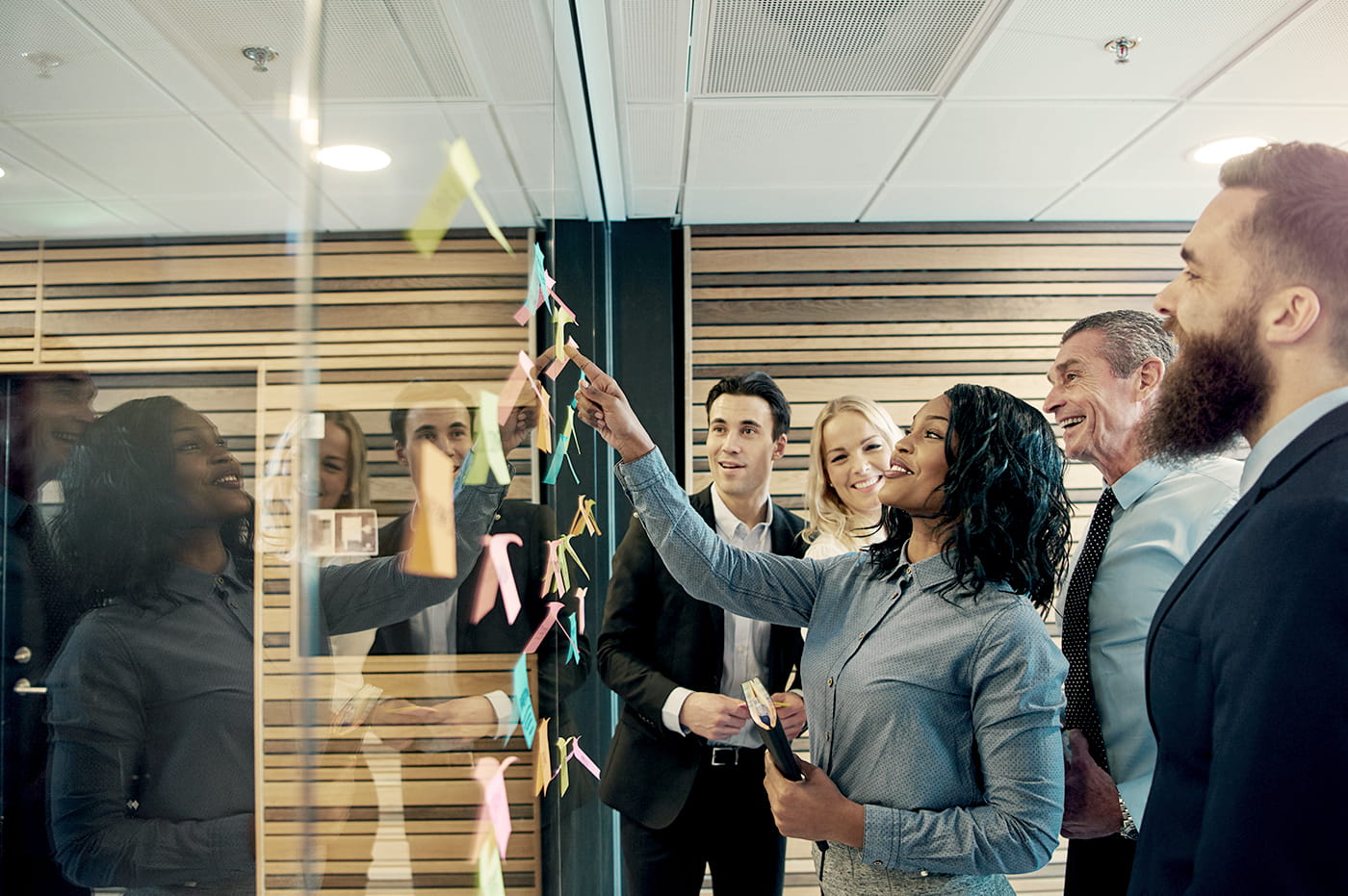 A diverse group of coworkers strategizing together in the office- guide card.