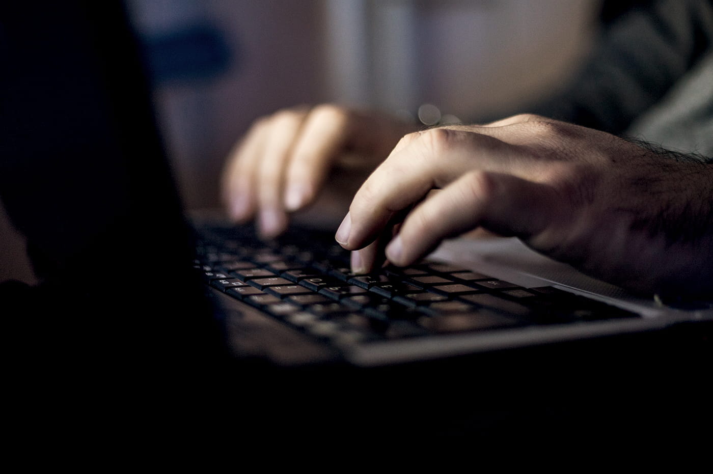 A person typing on a laptop.