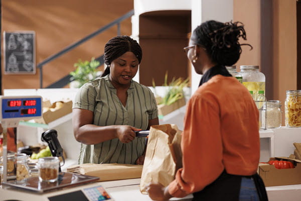 A woman checking out at a grocery store.