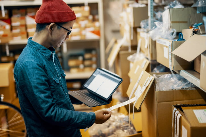 A man checking inventory in a warehouse.