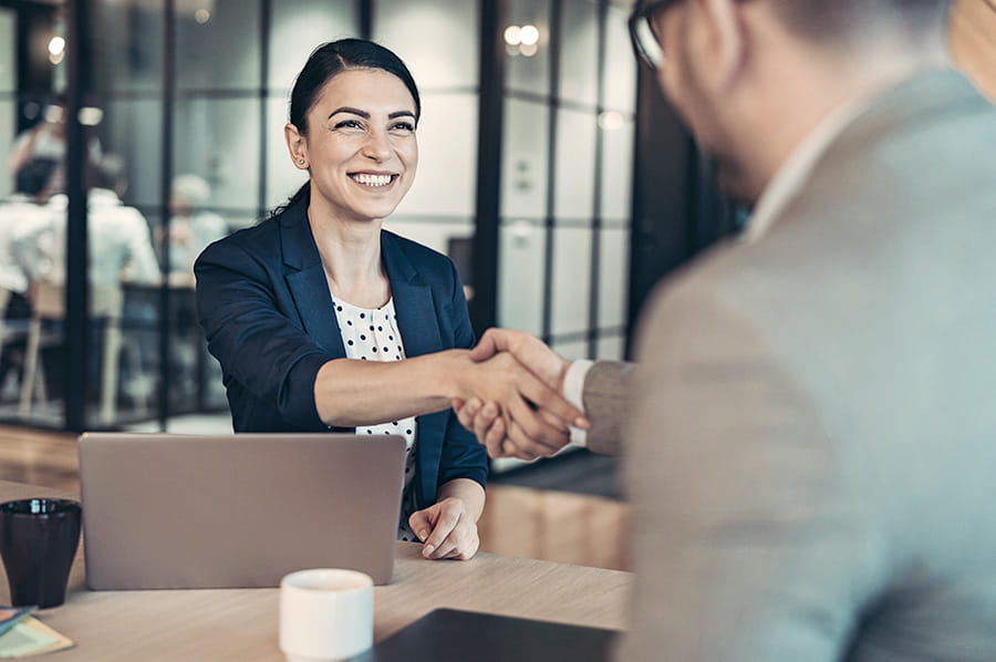 A woman shaking a man's hand