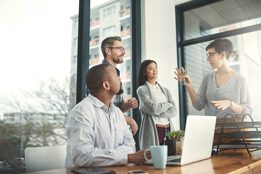 Woman talking to coworkers explaining something