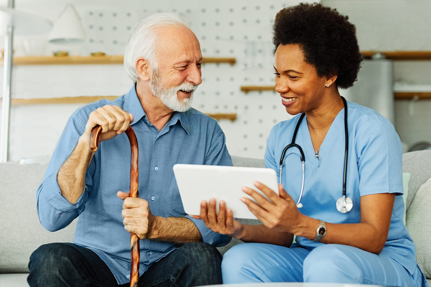 Doctor showing a patient something on a tablet device. 