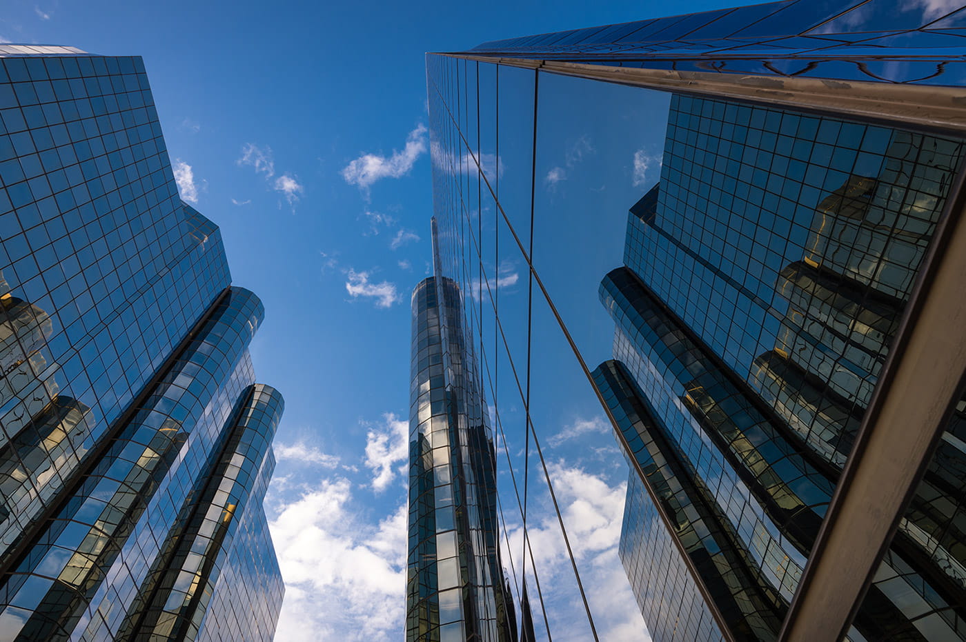 Some tall and reflective high-rises reaching up into the sky.