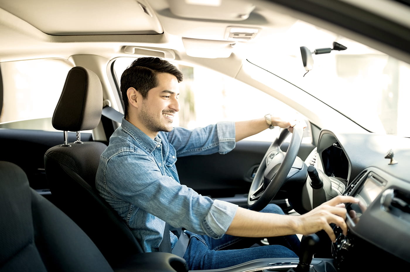 A man in the front seat of a car.