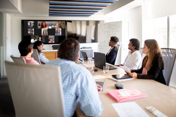 Coworkers in a hybrid meeting.